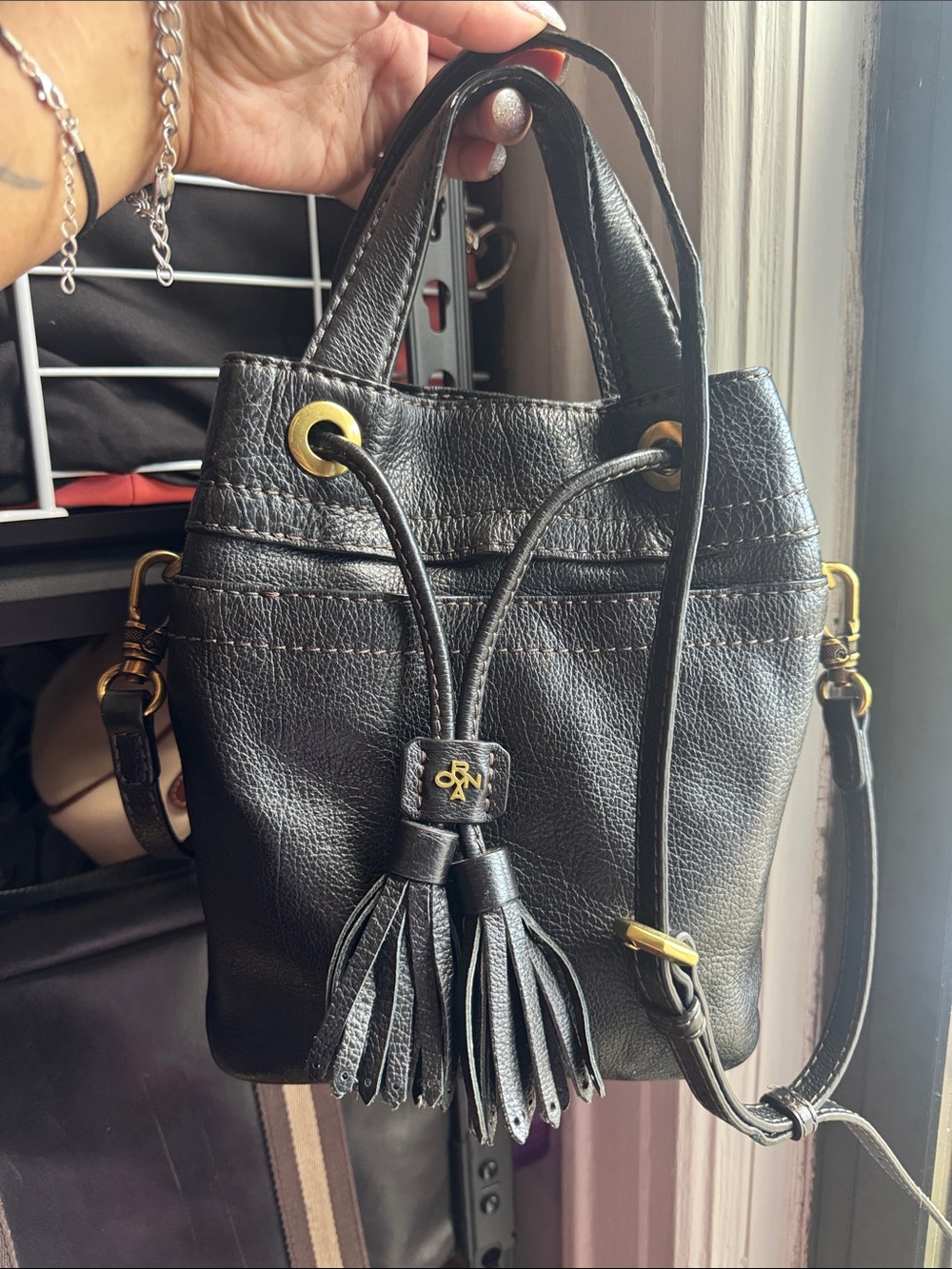 orYANY Black Leather Drawstring Tassel Crossbody Bag with Gold Hardware